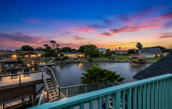 Sunset over Madeline Lake from Lakeview Landing's private dock — moments like this are why guests return to this Galveston waterfront home year after year.