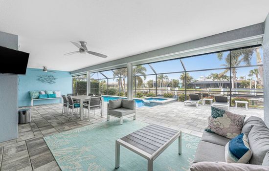 Furnished outdoor lanai with TV, pool, hot tub, grill