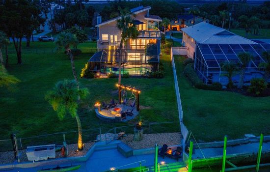 Private waterfront retreat with a heated saltwater pool, fire pit lounge, 45’ dock, and direct Gulf access—all just minutes from open water.