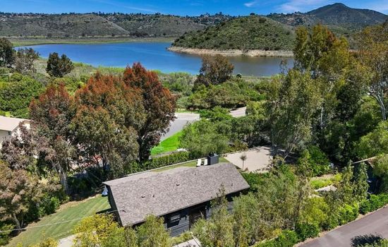 Aerial view showcasing the home's prime location just steps from Lake Hodges, offering breathtaking lake views and easy access to outdoor activities.