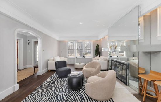 Modern furnishings and a striking mirror create a bright, inviting spot to unwind or catch up with the group.