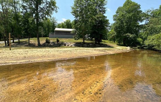 Peaceful riverbank right by the property.