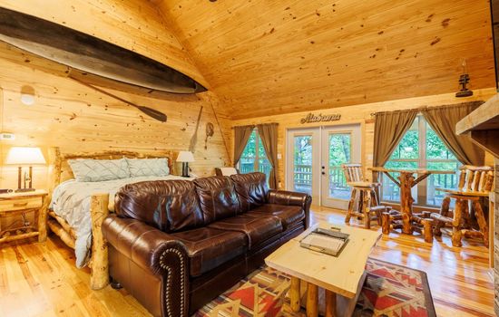 Cozy couch facing the indoor fireplace.