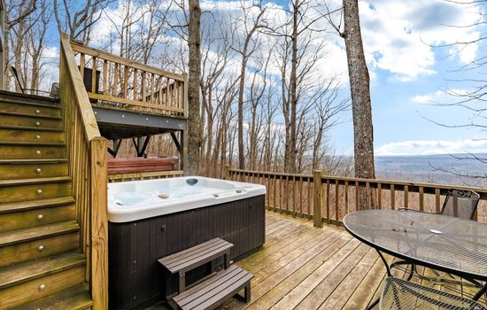 Hot tub on the lower deck with mountain, valley, and sunset views.