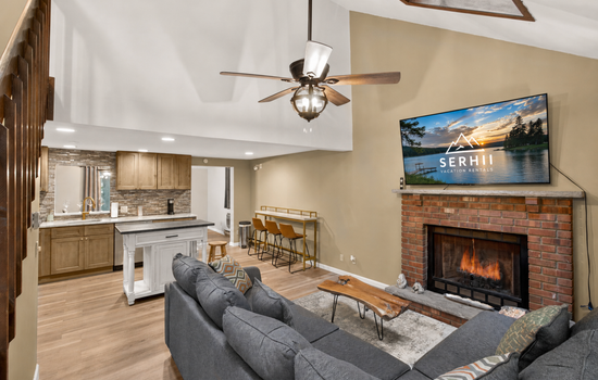 Living room with smart TV and comfortable sectional. Propane fireplace for colder months - Arrowhead Lake - Serhii Vacation Rentals