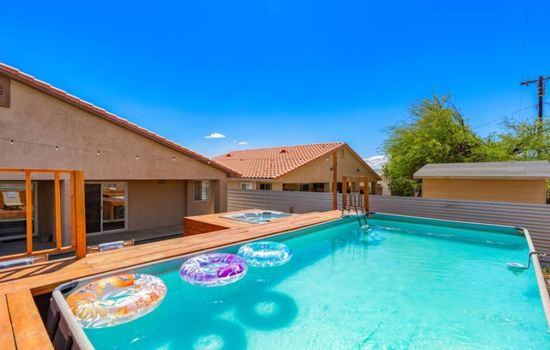 Private backyard pool framed by warm wood decking, ideal for sunny afternoons & easy outdoor lounging.