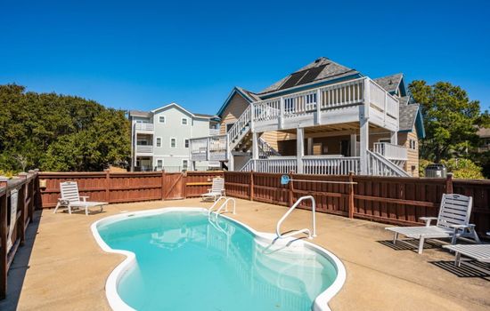 Sunlit backyard pool w/ fenced yard, perfect for cooling off after a day of coastal adventures.