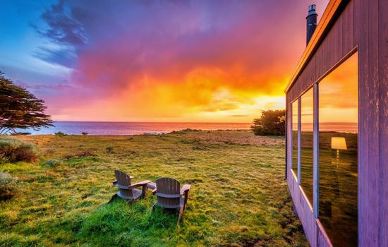 "The home is positioned to enjoy both sunrise and sunset views." Oceanfront Adirondack chairs to watch orange sherbet sundowns reflect the quiet transition from day to dusk.