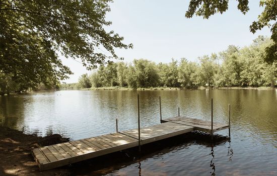 Private 10 ft dock with gradual shallow slope on a swimmable waterfront.