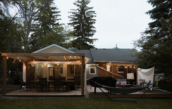 Your home for outdoor moments: roomy deck space and firewood ready for use.