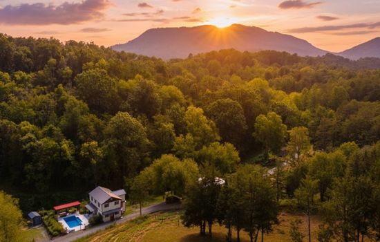Welcome to Maple Valley Farm: A wide shot of the iconic farmhouse nestled in the heart of the valley.