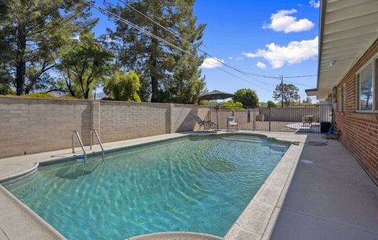 Sparkling private pool framed by desert landscaping, perfect for cooling off under sunny skies.