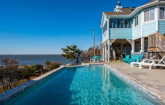 Infinity pool w/ sweeping sound views, perfect for cooling off as the water shimmers beyond.