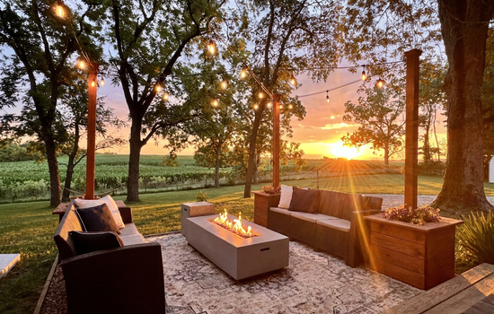 Magical patio area featuring an easy light propane fire table and comfortable lounge seating plus edison lighting for evening chill time.