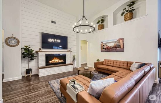 Electric fireplace and oversized sectional featured in the spacious living room space.