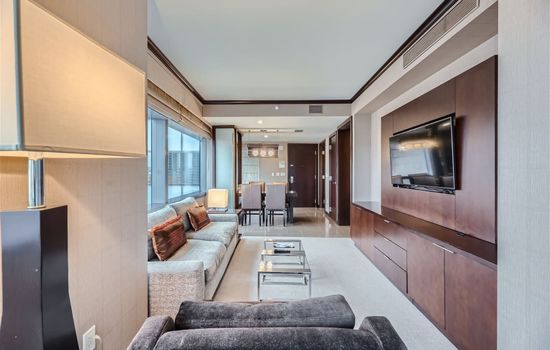 Separate living room with queen-size pull-out sofa bed, arm chair, workstation, coffee table, and 42" digital LCD flat-screen TV.