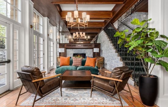 A beautifully furnished shared lounge with elegant lighting and vibrant seating located in the hotel’s common space and not inside your private room.