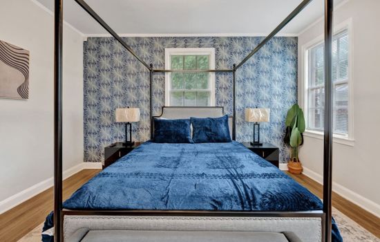 Master bedroom featuring a four-post king-size bed.