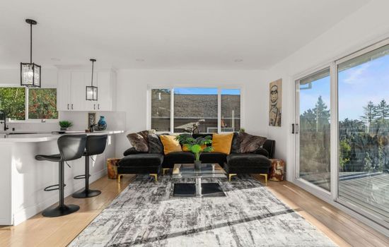 Cozy lounge setup with stylish decor and plenty of natural light for relaxing together.