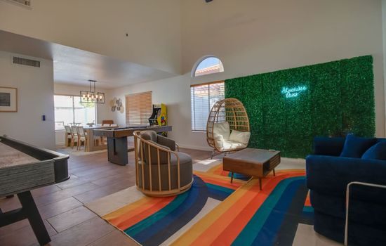 Bright and inviting living room with colorful accents and comfortable seating.