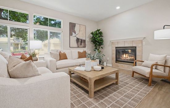 Bright and airy living room with comfortable seating and a cozy fireplace centerpiece.