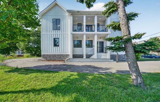 Inviting front entrance with covered porches perfect for relaxing outdoors.