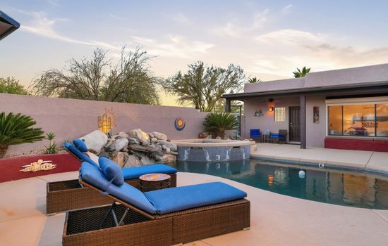 Resort style pool with lounge seating and relaxing outdoor space.