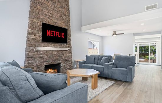 Cozy living room with fireplace and streaming ready entertainment.