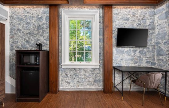 This is the private room you will be renting featuring stone walls, a mounted TV, and a dedicated workspace for added convenience.