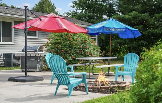 Outdoor Lounge: Bright umbrellas shade a fabulous firepit, perfect for s'mores and starry nights!