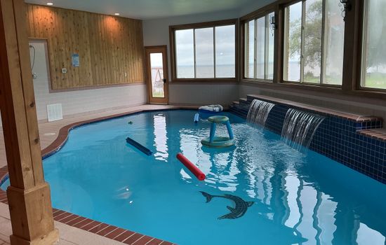 Indoor pool with lake view and waterfalls