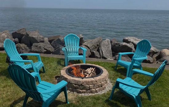 Lakeside fire pit with turquoise chairs