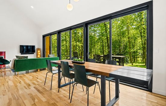 Dining area with floor-to-ceiling forest views