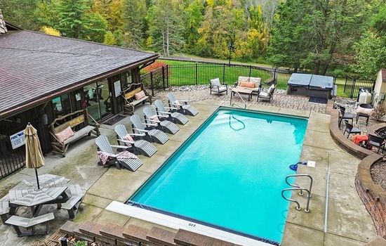 Outdoor pool with surrounding lounge chairs