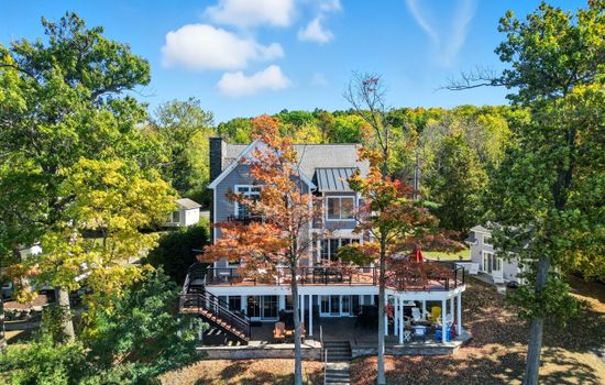 Lakeside exterior of the home with multiple decks and lake access.