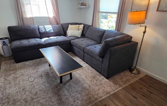 Sectional sofa surrounding a rectangular coffee table