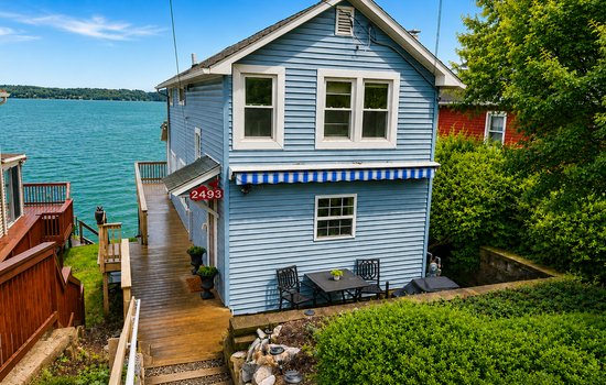 Blue cottage exterior near the shoreline
