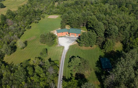 Aerial view of the home and long driveway