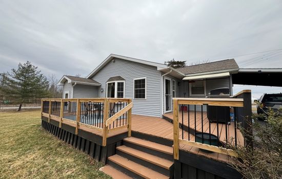 Home exterior with raised wooden deck