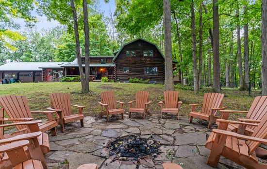 Wooded fire pit area with outdoor seating