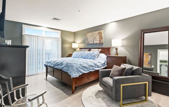 Bedroom with warm wood furnishings and television