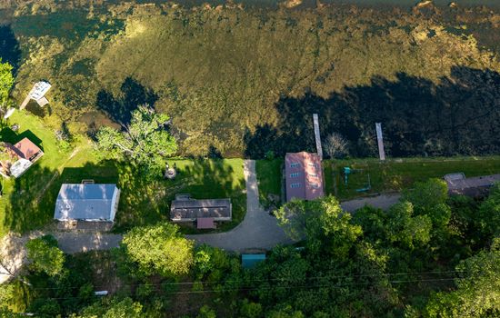 Aerial view of three wooded cabins