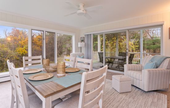 Four-season dining room with wraparound windows