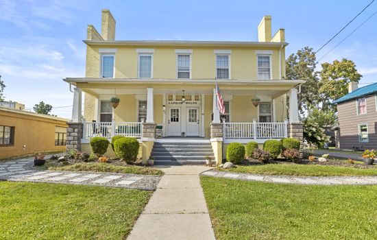 Yellow historic home with covered front porch