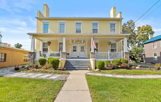 Yellow historic home with covered front porch
