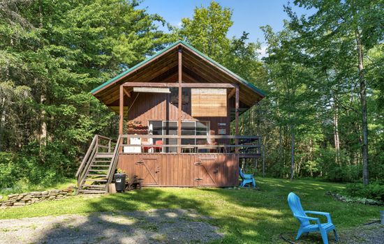 Wood cabin surrounded by mature trees